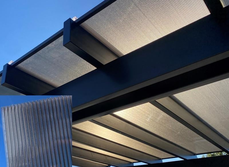 Covered pergola structure with polycarbonate roof and a blue sky background